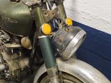 a old motorcycle that is sitting in a garage