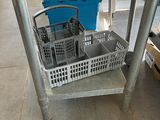 a metal cart with two baskets on top of it