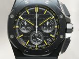a close up of a watch with a black face and yellow accents