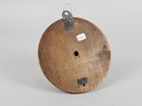 an old wooden spool with a tag on it sitting on a table
