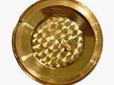 a close up of a gold plate on a white background