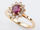 a close up of a pink sapphire and diamond ring on a white background