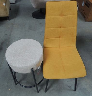 a yellow chair and a white stool in a warehouse