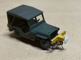 a toy truck with a snow plow attached to the front of it