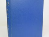 a blue book sitting on top of a white table
