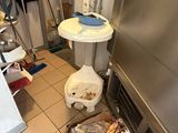 an image of a kitchen with a sink and a trash can