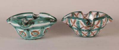 pair of green and white vases sitting on top of a table