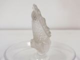 a glass plate with a fish on it on a table