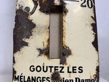 a metal thermometer with a black and white design on it