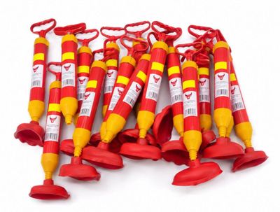 six red and yellow fire extinguisors are lined up on a white surface
