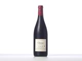 a bottle of red wine sitting on top of a white table