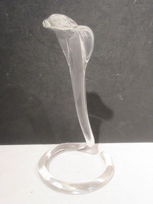 a glass sculpture of a flower on a stand