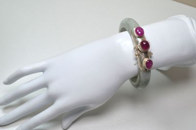 a white mannequin hand with a bracelet on it