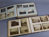 two open books with pictures of buildings on them sitting on a table