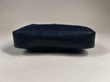a close up of a blue purse on a white surface