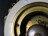 a close up of a clock with a chain around it