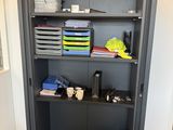 a bookcase with many items on it in a room