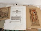 many old books on a table with pictures on them