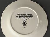 a close up of a white plate with black writing on it