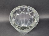 a crystal bowl on a table with a black background