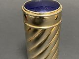 a gold cup with a lapis stone inside of it