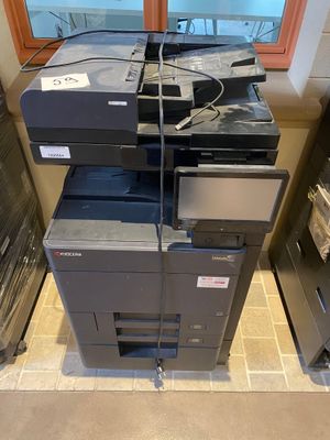 a stack of printers sitting on top of each other in a room
