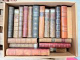 a box full of old books sitting on a table