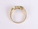 a close up of a gold ring on a white surface