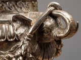 a silver vase with an elephant head on it