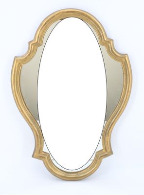 an image of a gold oval shaped mirror on a white wall