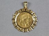 an image of a close up of a gold coin in a pendant