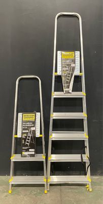 two step ladders are standing next to each other in front of a wall