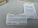 two tags on a table that show the name of a perfume