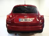 a red car that is parked in a white room