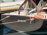 a small boat that is tied up to the dock