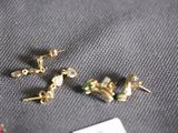 three pairs of earrings are laying on top of a table