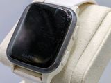a white apple watch with a black face on display