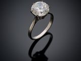 a close up of a diamond ring on a black surface