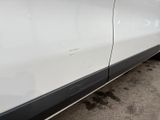 a white car with a black stripe on the side of it