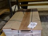 a large stack of wood sitting on a pallet in a warehouse