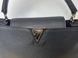 a black and gold handbag with a gold handle