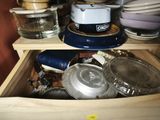 a drawer full of dishes and glassware in the kitchen