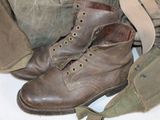 a pair of brown boots and a bag on a table