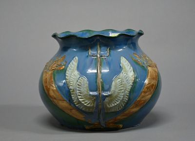 a blue vase with a gold decoration on it