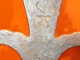 a metal sculpture of a tree with a face on it