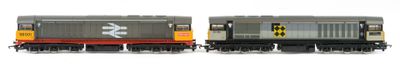 two trains that are sitting side by side on the tracks