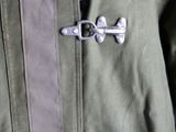 a close up of a jacket with buttons on it