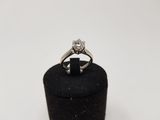 a close up of a diamond ring on a black ring holder