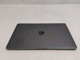 a black apple laptop sitting on a white surface