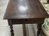 a table that is sitting in a room with many chairs